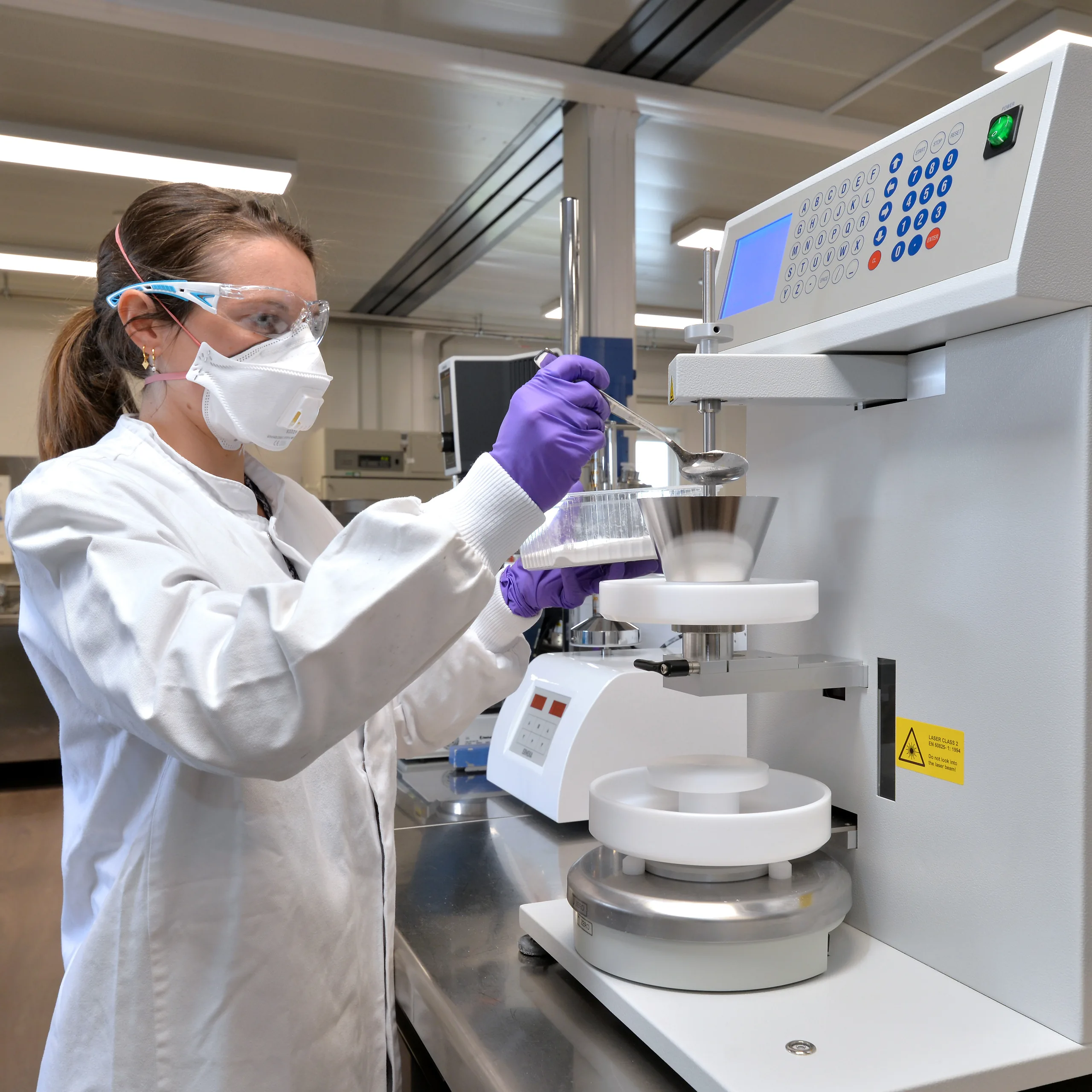 CHI lab worker at machine