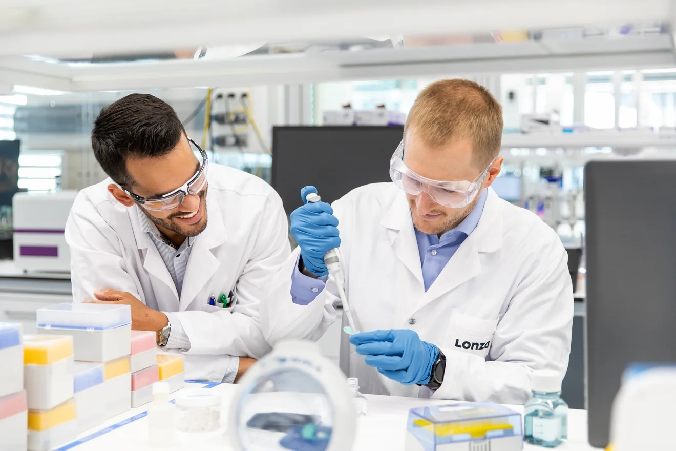 Two men working in the lab micro pipetting. 